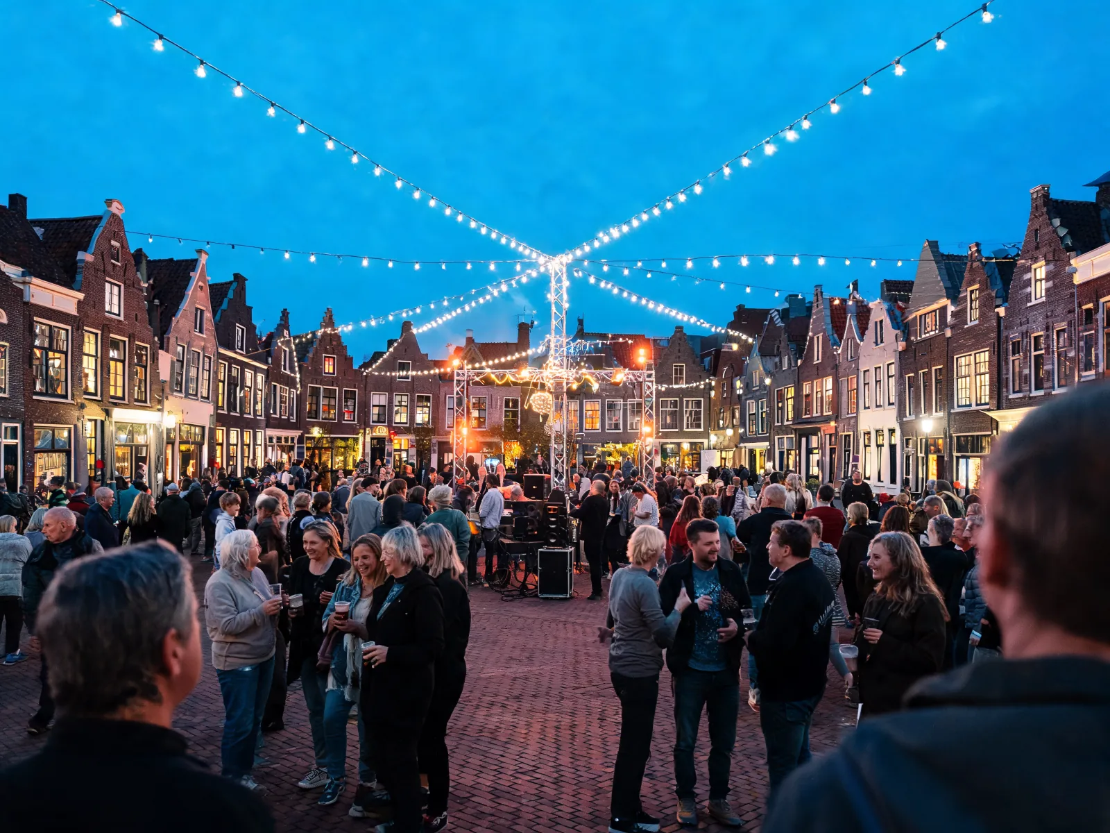 Conceptbeeld van een cultureel avondmoment op een Nederlandse dorpsmarkt.